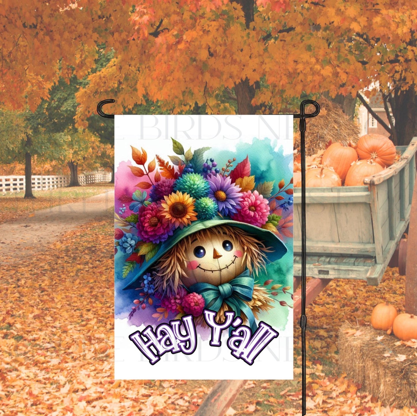 A beautiful Autumn Garden Flag with an adorable Scarecrow and Fall flowers with a Hay Yall message