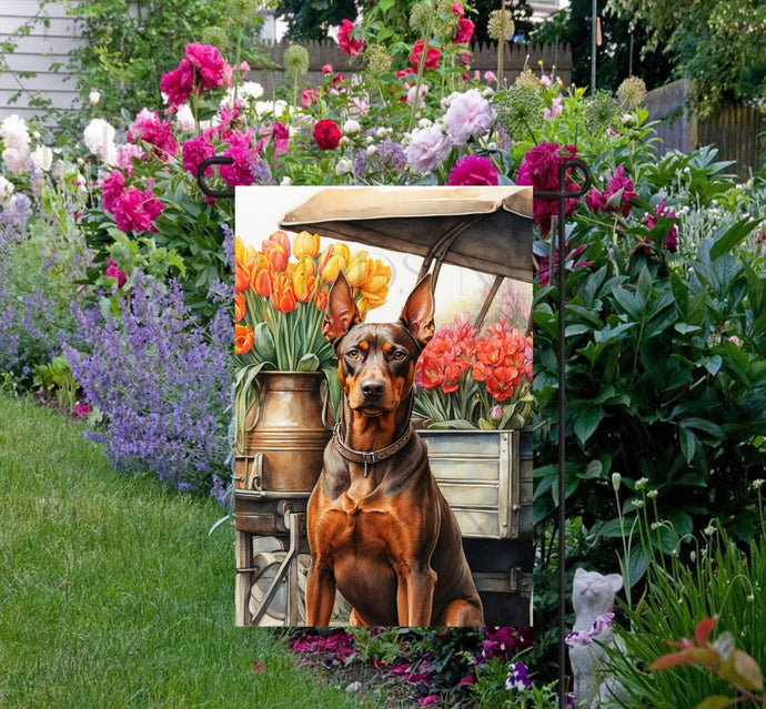 A beautiful red Doberman Pinscher dog surrounded by gorgeous flowers.