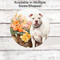 A white Pit Bull Dog on a flower cart full of Spring Flower