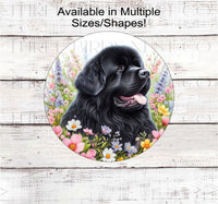 
              A black Newfoundland dog surrounded by beautiful Spring flowers
            