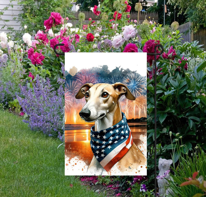 An adorable Greyhound Dog wearing an American Flag Bandanna on a Beach with Fireworks in the background.