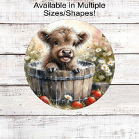 An adorable farm scene with a baby Scottish Highland Cow Calf taking a bath in a wooden tub with farm fresh strawberries around the tub.