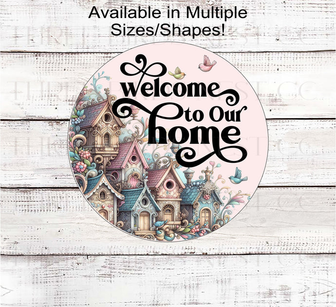 A beautiful pastel colored sign with adorable birdhouses and a Welcome to Our Home message.