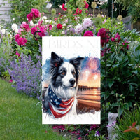 An adorable Border Collie Dog wearing an American Flag Bandanna on a Beach with Fireworks in the background.