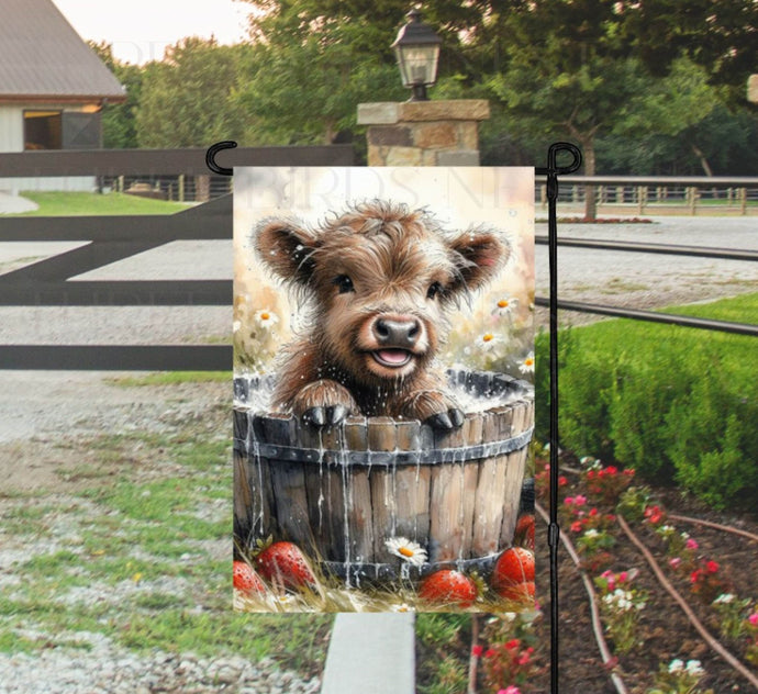 An adorable farm scene with a baby Scottish Highland Cow taking a bath in a wooden tub with farm fresh strawberries around the tub.