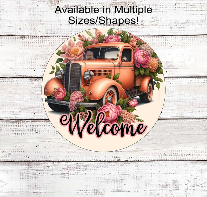 A beautiful sign with a dark Peach colored vintage truck filles with pink and peach colored flowers. Peach is Pantone's color of the year.