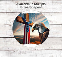 
              A beautiful Bald Eagle bows in front of a wooden cross with am American Flag sash.
            