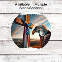 A beautiful Bald Eagle bows in front of a wooden cross with am American Flag sash.