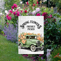 A beautiful green vintage old truck full of Spring flowers.