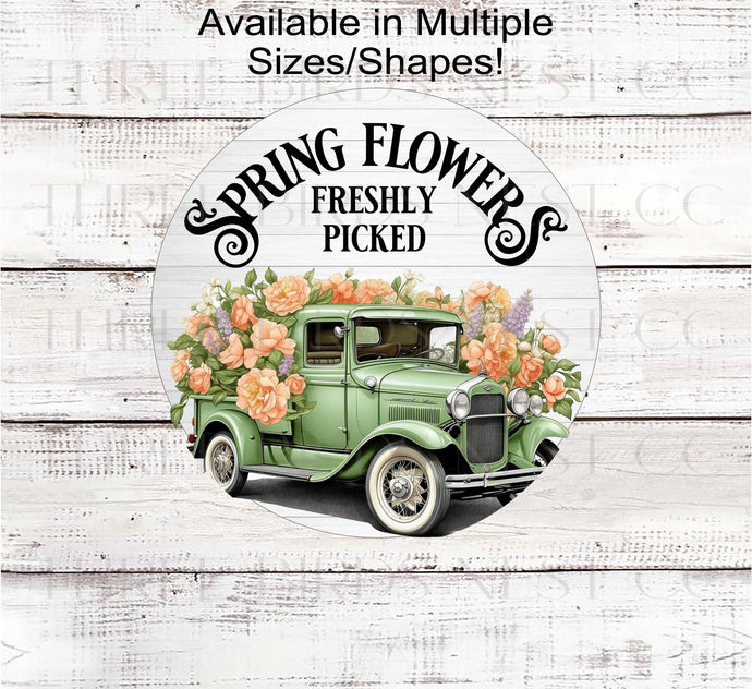 A beautiful green Vintage Truck filles with colorful Spring Flowers for the Farmers Market