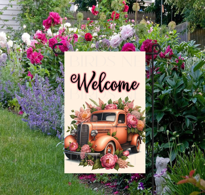 A beautiful peach colored vintage old truck full of Spring flowers.