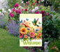 A Welcome Garden Flag with brightly colored flowers and Hummingbird.