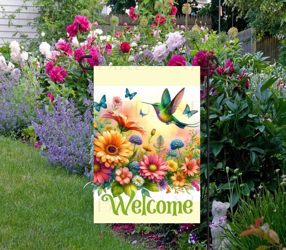 A Welcome Garden Flag with brightly colored flowers and Hummingbird.