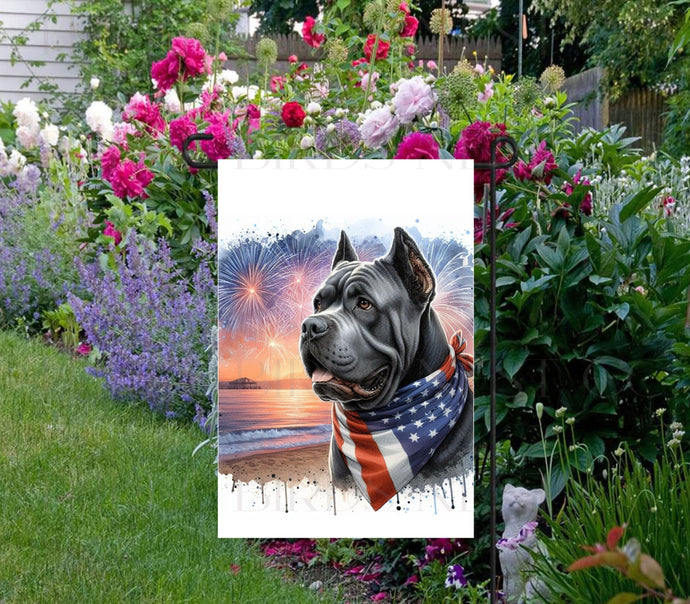 An adorable grey Cane Corso Dog wearing an American Flag Bandanna on a Beach with Fireworks in the background.