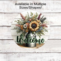 A beautiful rustic metal milk can filled with Sunflowers and other flowers and greenery with a Welcome message.