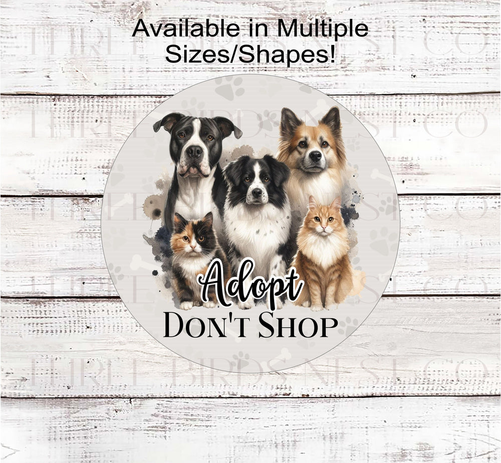 Adopt Dont Shop Wreath Sign with adorable dogs and cats on a pawprint background.