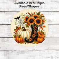 A beautiful Fall and Halloween Scene with a fancy Witch Boot filled with Sunflowers along with a spider web, a bat and white and orange Pumpkins.