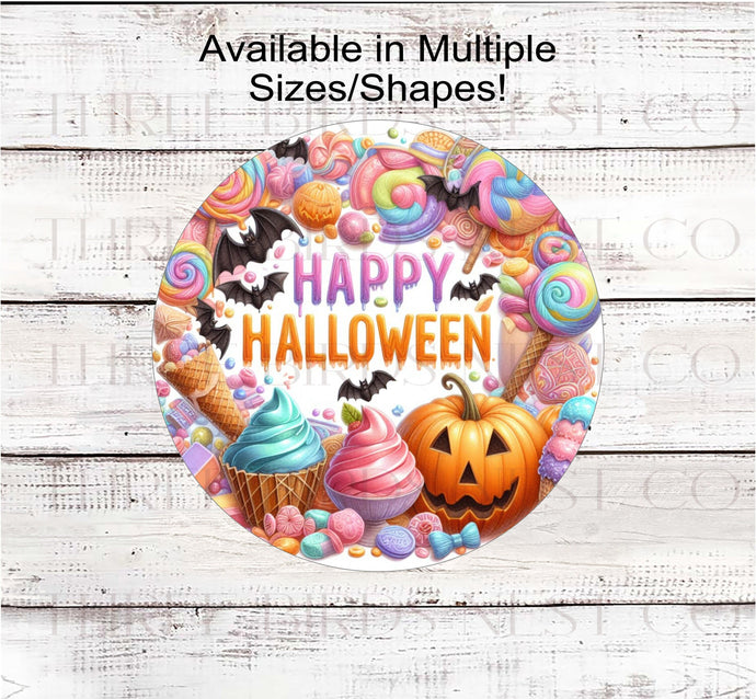 An adorable Halloween Wreath Sign filled with pastel candy, ice cream, and cupcakes with a jack-o-lantern and bats.