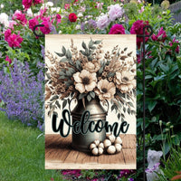 This beautiful double-sided Garden Flag features a rustic farmhouse scene with a metal milk can full of Magnolias, cotton bolls and other flowers with a Welcome message.