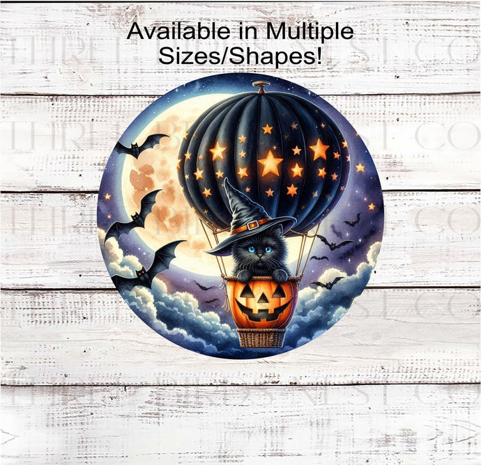 An adorable Black Halloween Cat in a Hot Air Balloon with aa jack-o-lantern basket and bats and stars.