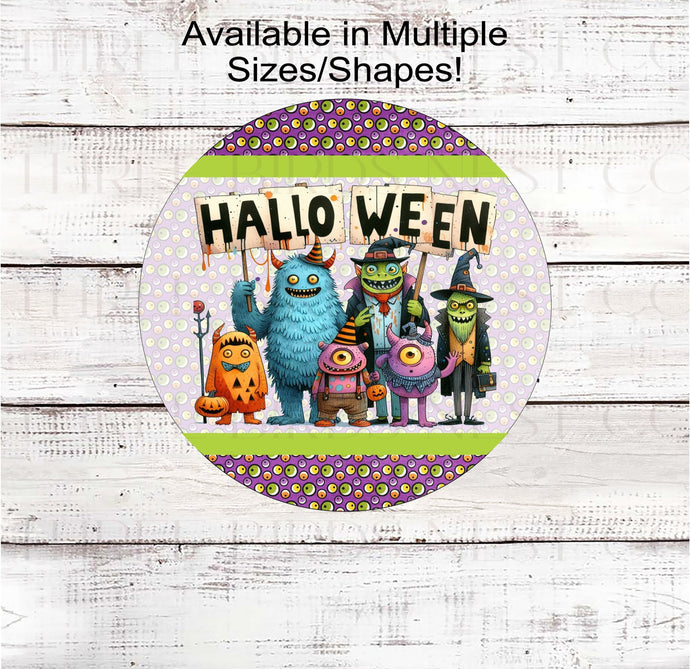 An adorable group of Monsters with a Halloween sign on a background of silly eye balls.