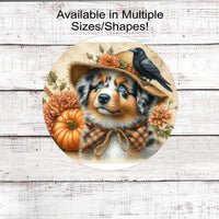 An adorable Australian Shepherd dog dressed as a Fall Scarecrow.