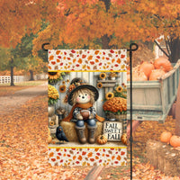 A beautiful primitive Fall Sweet Fall Garden Flag with an adorable Scarecrow holding a Football surrounded by Mums, pumpkins and a Crow with a Fall leaves background.