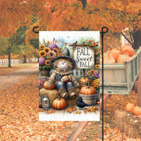 A beautiful Fall Sweet Fall Garden Flag with a cute Scarecrow holding a football and surrounded by pumpkins and mums.