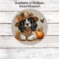 An adorable English Springer Spaniel puppy dog in a scarecrow hat with his black crow friend.