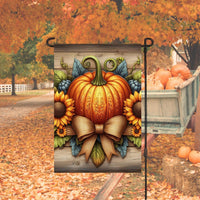 A beautiful rustic Fall Garden Flag with a decorated carved Pumpkin surrounded by sunflowers and a burlap bow.