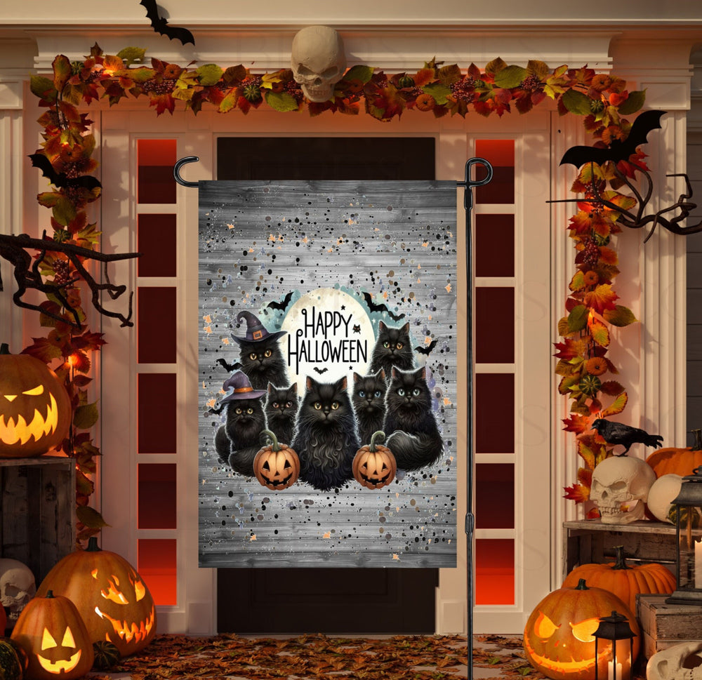 An adorable Halloween Garden Flag featuring a group of Black Cats and a Happy Halloween message.