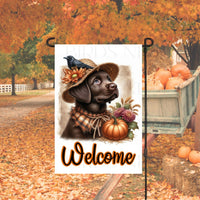 An adorable Chocolate Labrador Retriever Puppy Dog dressed as a Scarecrow with a Welcome Fall message.