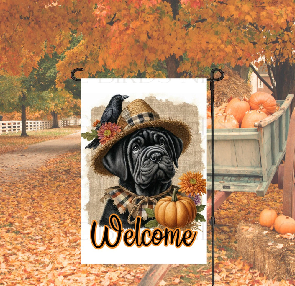 An adorable black Cane Corso Mastiff Puppy Dog dressed as a Scarecrow with a Welcome Fall message.