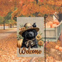 An adorable black Newfoundland Puppy Dog dressed as a Scarecrow with a Welcome Fall message.