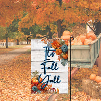 A beautiful Autumn Garden Flag with crocheted pumpkins, leaves and pinecones with a message stating Its Fall Yall.