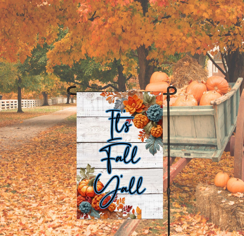 A beautiful Autumn Garden Flag with crocheted pumpkins, leaves and pinecones with a message stating Its Fall Yall.