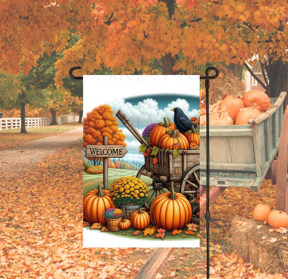 A beautiful Autumn Garden Flag with a Welcome sign, a pumpkin wagon with a black Crow and colorful Chrysanthemums.