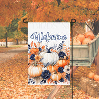 A beautiful Fall Welcome Garden Flag with orange and navy-blue pumpkins and Fall flowers and foliage.