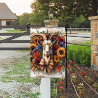 A rustic Farmhouse Garden Flag featuring a Goat surrounded by Sunflowers and beautiful florals with a burlap bow.