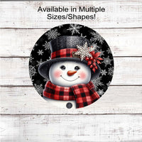 An adorable Snowman dressed in a red and black hat and scarf on a snowflake black background.