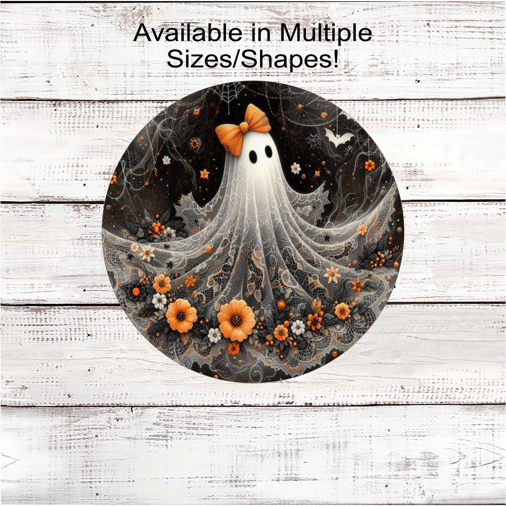 An adorable Halloween Ghost with an orange bow on her head and flowers around the bottom of her lacey sheet.