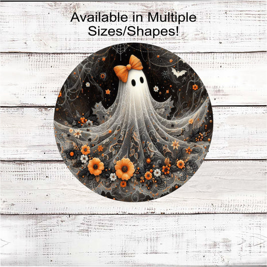 An adorable Halloween Ghost with an orange bow on her head and flowers around the bottom of her lacey sheet.