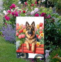 
              A beautiful German Shepherd in a wooden cart full of Spring flowers.
            