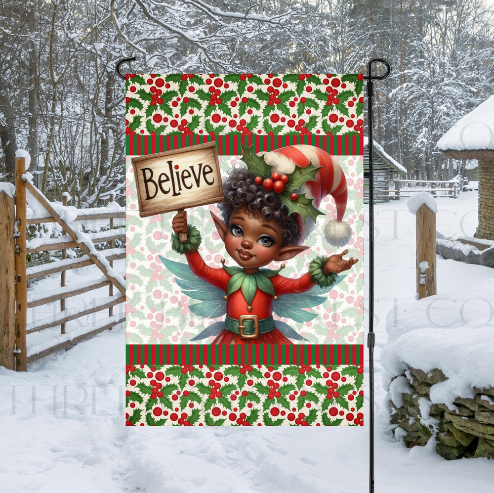 A beautiful double-sided Garden Flag featuring an African American Elf holding a sign reminding you to believe in the magic of Christmas!