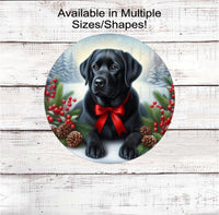 
              A black Labrador Retriever with in festive Winter setting and a red bow around his neck.
            