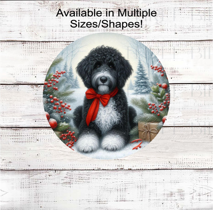 A black and white Poodle dog with in festive Winter setting and a red bow around his neck.