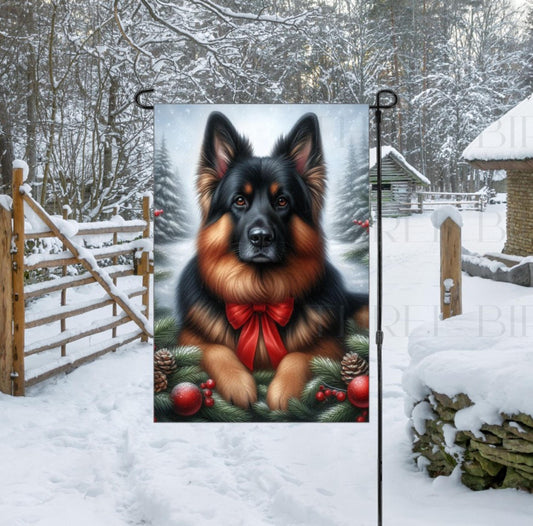 A black and red German Shepherd in a Winter setting with a red bow on