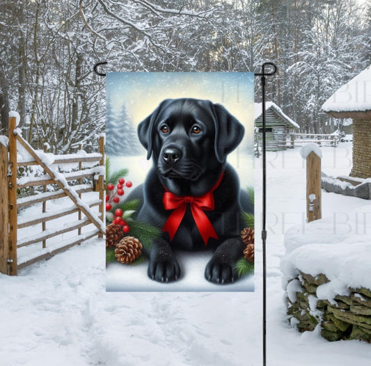 A beautiful black Labrador Retriever in a Winter setting wearing a red bow.