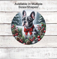 
              A beautiful merle French Bulldog wearing a red bow in a Winter setting
            