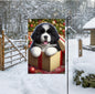 An adorable Landseer Newfoundland puppy in a Christmas Gift Box.